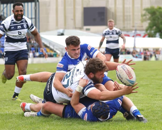 Zach Fishwick appears to be losing control of the ball as he reaches out to try to score for Featherstone Rovers at Barrow. Picture: John Victor