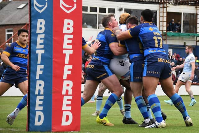 Wakefield Trinity players show the sort of strong goal-line defence that earned them praise from head coach Mark Applegarth. Picture: Rob Hare