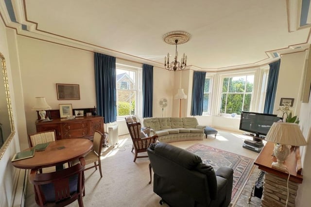 The light-filled lounge has a fireplace, and bay and sash windows.