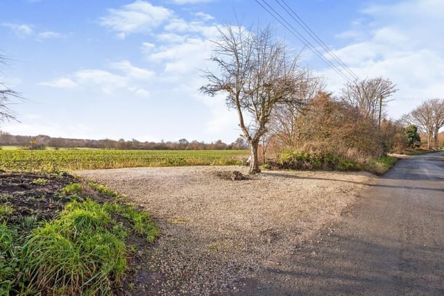 Fields and farmland give open views across the road from the house location.