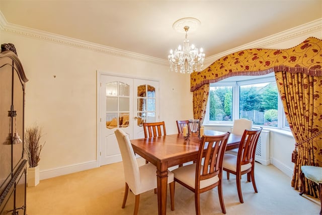 The dining room with bay window leads to a snug or family room, which is open plan to the kitchen.