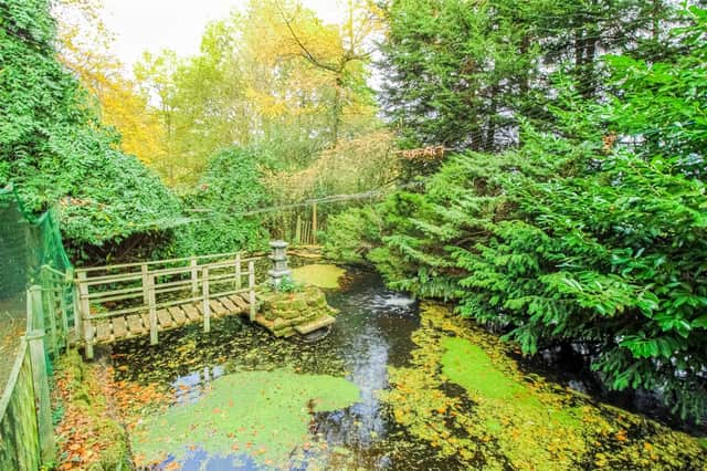 Beautiful gardens to the rear of Woodend Cottage include an ornamental fish pond.