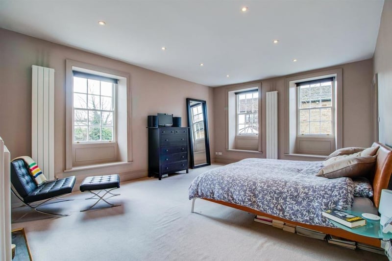 The principal bedroom includes two contemporary style vertical central heating radiators, a Georgian hob grate fireplace and a spacious walk in wardrobe.