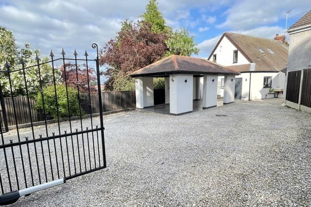 Wrought iron electric gates lead in to the property's driveway.