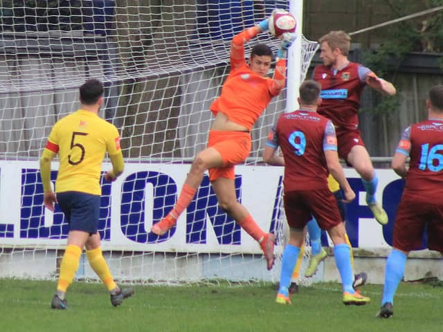 Pontefract Collieries' Spencer Clarke challenges Tadcaster Albion goalkeeper Josh Mazfari for a high ball into the box. Picture: Keith Handley