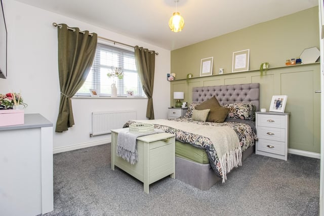 A spacious double bedroom with wall panelling.
