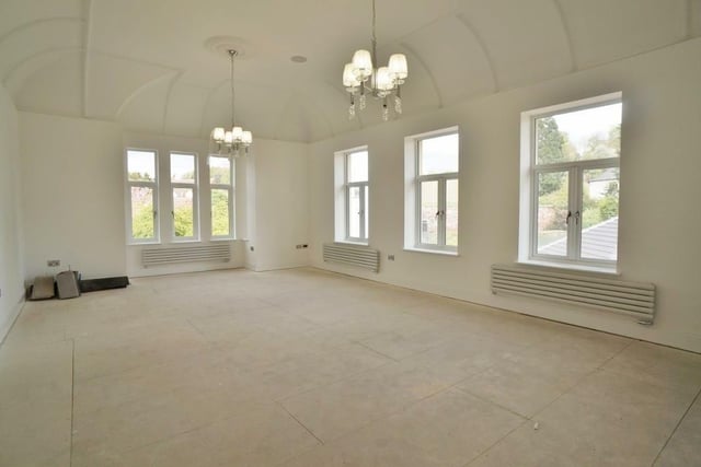 Once the great ballroom now a stunning retreat with original ceiling detail and two ceiling rose with concealed ceiling lighting and chandeliers there's also bespoke cabintery for a drinks station,