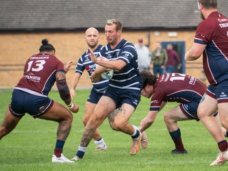 Lions star Josh Hardcastle tests the Trojans' line.