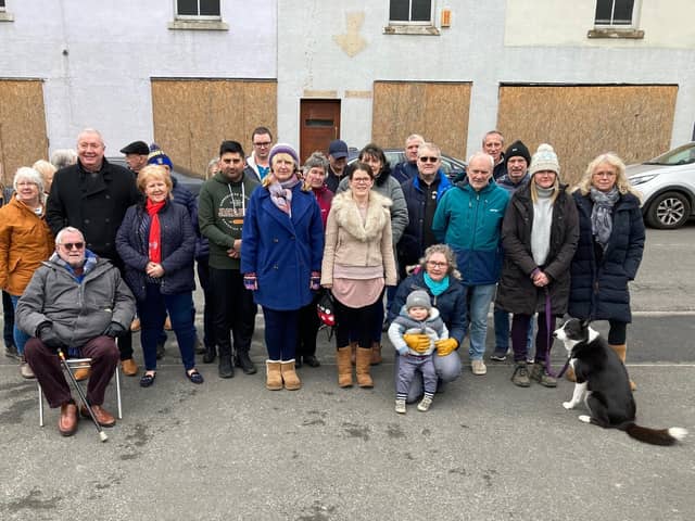 Village residents have objected to a scheme to convert a derelict former business premises into flats and retail units.