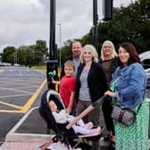 Joshua Glover pushes the button at one of Newton Bar’s 11 pedestrian and cycling crossing with Claire Glover and granddaughter Lyla Harmer, Coun Matthew Morley, Cabinet Member for Planning and Highways, and Donna Ambler,  Project Officer for Transport Policy & Delivery at West Yorkshire Combined Authority.