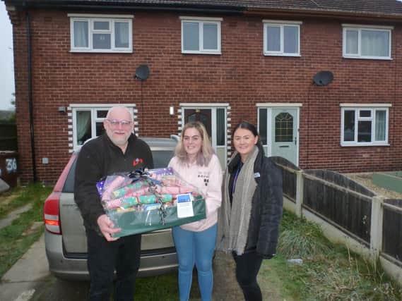 Kevin Dobson of the Community Awareness Programme (l), Rachel Carroll of the Children First organisation (r), with single mother of one Caitlyn and her hamper donated by an 
Express reader.