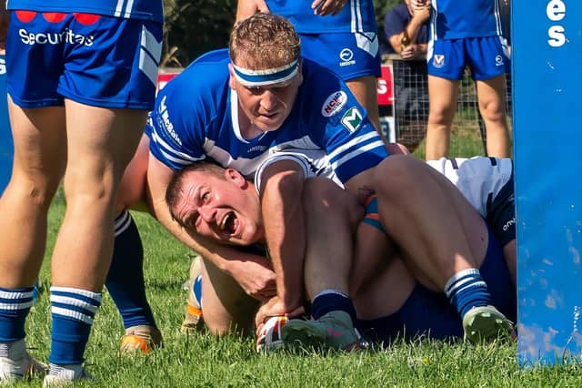 Winners are grinners: Featherstone Lions captain Jordy Walker scores under the posts against Barrow Island.