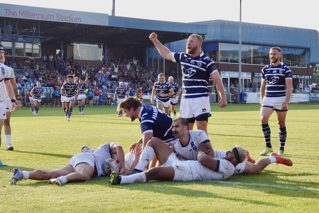 Brad Day leads the cheers as Chris Hankinson touches down for a Featherstone Rovers try.