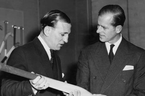 Prince Philip, Duke of Edinburgh (1921-2021), on right, talks to Len Hutton (1916-1990), former Yorkshire and England cricketer, during his tour of the cricket bat manufacturing shop at the Slazenger sporting goods factory in Horbury, West Yorkshire, England on March 16, 1957. (Photo by Pool/Paul Popper/Popperfoto via Getty Images)