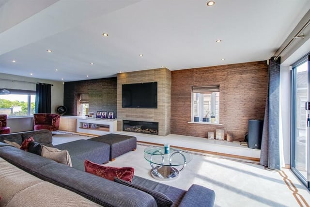 This incredible living room features UPVC double glazed bi-folding doors opening onto the extensive patio area to the rear garden, LED spotlights to the ceiling, a column central heating radiator, a luxury Bellfire gas fire with balanced flue with decorative wood and a glass pane built into the impressive media unit.