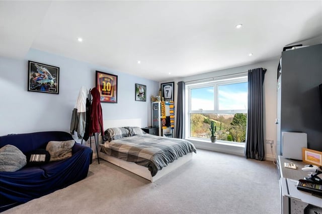 A double bedroom with a huge picture window and a stunning view outside.