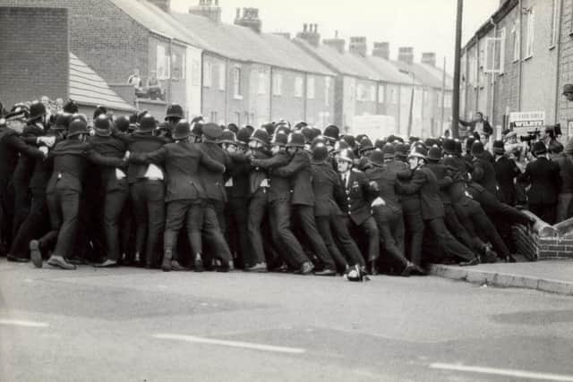 A line of police contains pickets in a side street opposite Allerton Bywater Colliery, August 1984