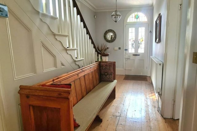 A bright entrance hallway, with staircase up, leads into the house.