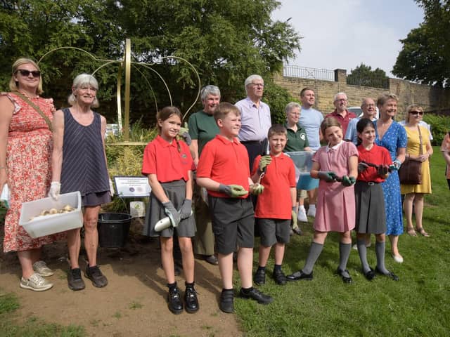 Children from St Giles' C of E school were joined by Yvette Cooper MP to plant spring bulbs at Friarwood Valley Gardens, Pontefract.