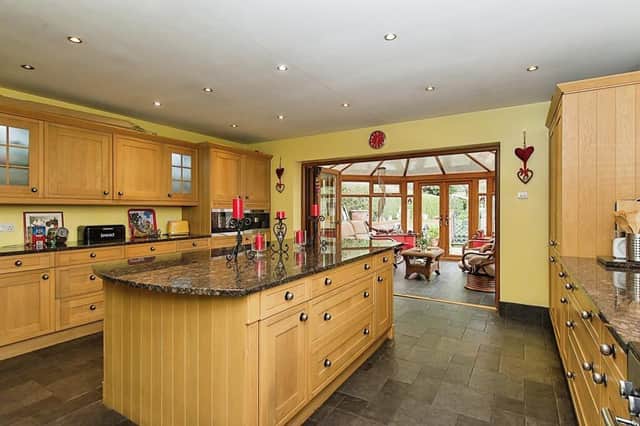 The stunning breakfast kitchen is open plan to the conservatory.