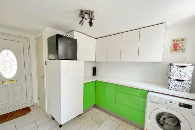 A handy utility room is fitted with units to match the kitchen.