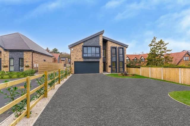 A warm welcome to the new and exclusive five-bedroom home on Kighill Lane in Ravenshead, which is on the market with a guide price of £800,000. The sweeping driveway leads to a double garage.