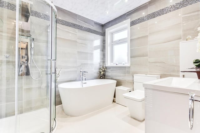 A family bathroom with a stylish, contemporary suite including bath and walk-in shower.