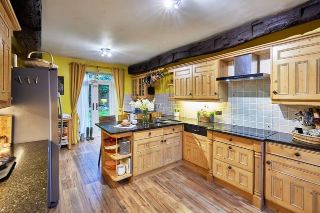 The kitchen with French doors to the garden, has fitted units and integrated appliances, with granite worktops.
