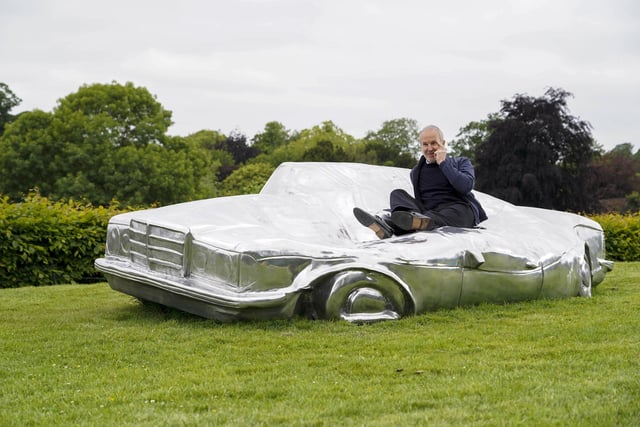 Austrian artist Erwin Wurm with his work 'The German Couch' (2021) at the 'Trap of the Truth' exhibition in Yorkshire Sculpture Park on Saturday (10 June).
