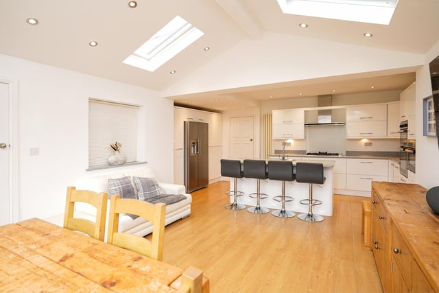 The kitchen is fitted with a range of modern wall and base cupboards and integrated appliances.