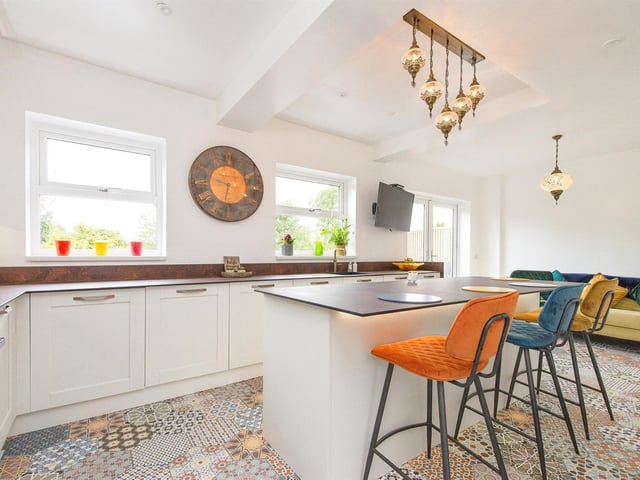 The kitchen extends to a family seating area with access out to the garden.