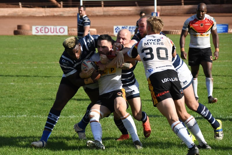 Bradford Bulls are driven backwards by Featherstone Rovers tacklers.