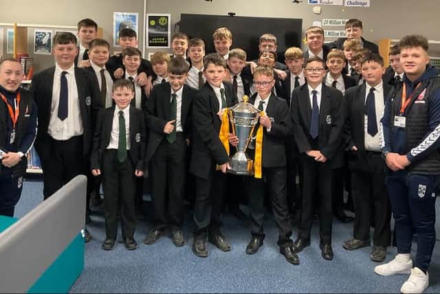 Ex-Brigshaw High School student Tom Halliwell, right, and his England wheelchair rugby league teammate, Nathan Collins, left, on a visit to Tom's old Castleford school with World Cup trophy.