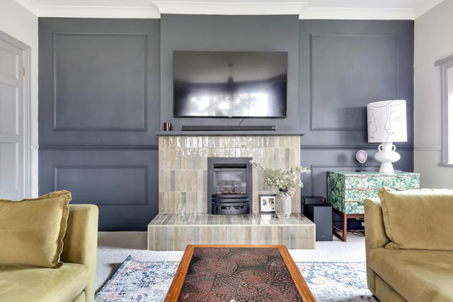 The feature tiled fireplace in the living room, with a cosy gas fire.