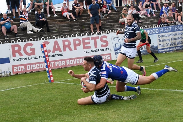 Craig Hall is about to touch down over the line for a try.