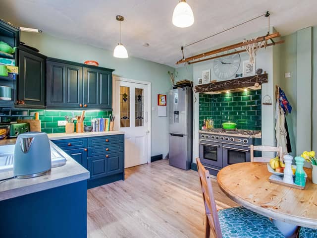 The property's breakfast kitchen has a range cooker, and an original creole, with an archway to a pantry.