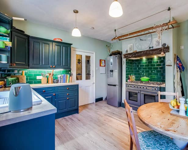 The property's breakfast kitchen has a range cooker, and an original creole, with an archway to a pantry.