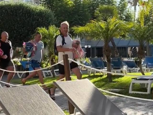 Video filmed at the Melia Hotel, in Benidorm, Spain, shows tourists - armed with their beach towels - hastily making their way to the poolside furniture. (SWNS)