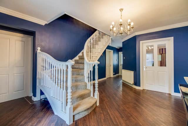 An entrance hallway with feature staircase.