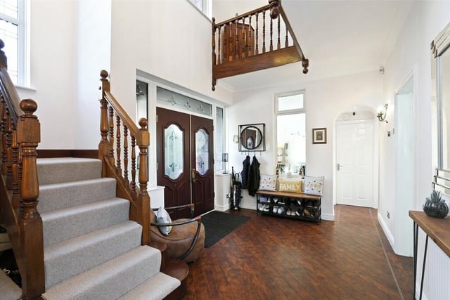 This charming hallway includes double opening, double glazed entrance doors, a large designer arched window and amitico flooring.