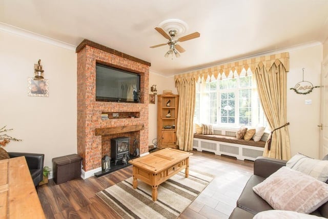 This lovely reception room is fit with a stunning brick fireplace.