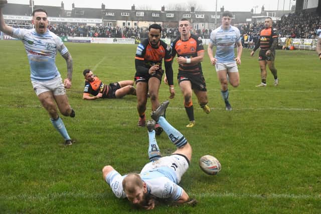 Brad Day dives over to score the opening try for Featherstone Rovers against Castleford Tigers. Picture: Rob Hare