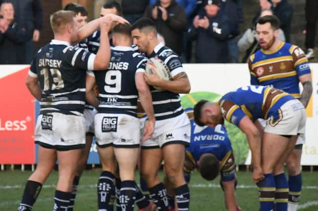 Featherstone Rovers celebrate Caleb Aekins' try against Whitehaven.