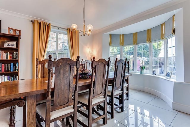 The dining room is filled with natural light from the large feature bay window.