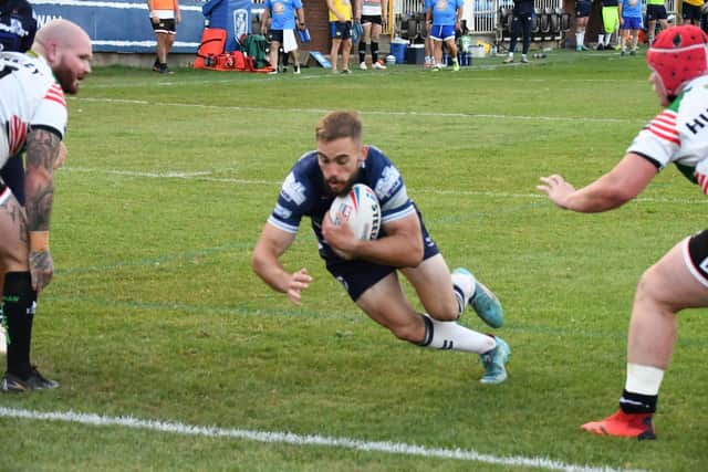 Connor Jones dives over for one of his five tries for Featherstone Rovers against Workington Town. Picture: Rob Hare