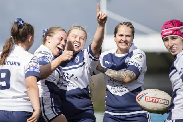 Featherstone Rovers players celebrate Katie Evans' try. Picture: John Victor