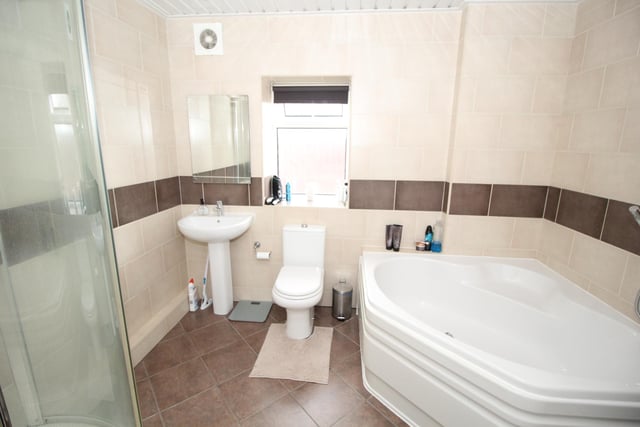A large corner bath features within the bathroom suite.