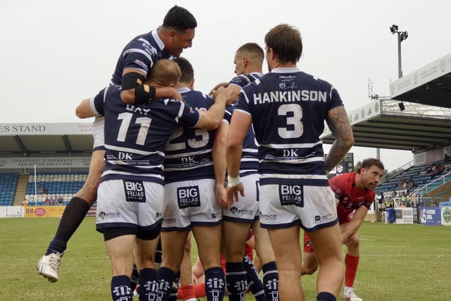 Featherstone Rovers celebrate scoring one of their nine tries.