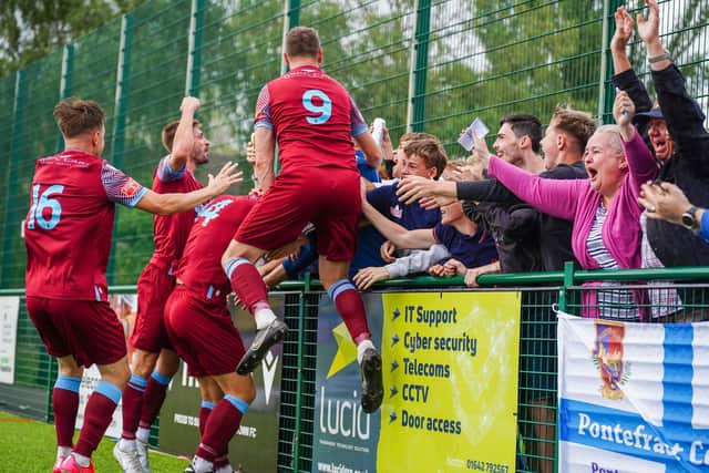 Pontefract Collieries players and supporters celebrate the winning goal at Stcokton Town. Picture: Josh Harper