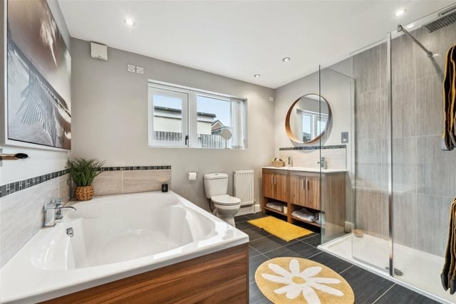 This lovely bathroom features a standalone shower room with underfloor heating, a substantial contemporary bathroom with a double freestanding bath and shower underfloor heating.